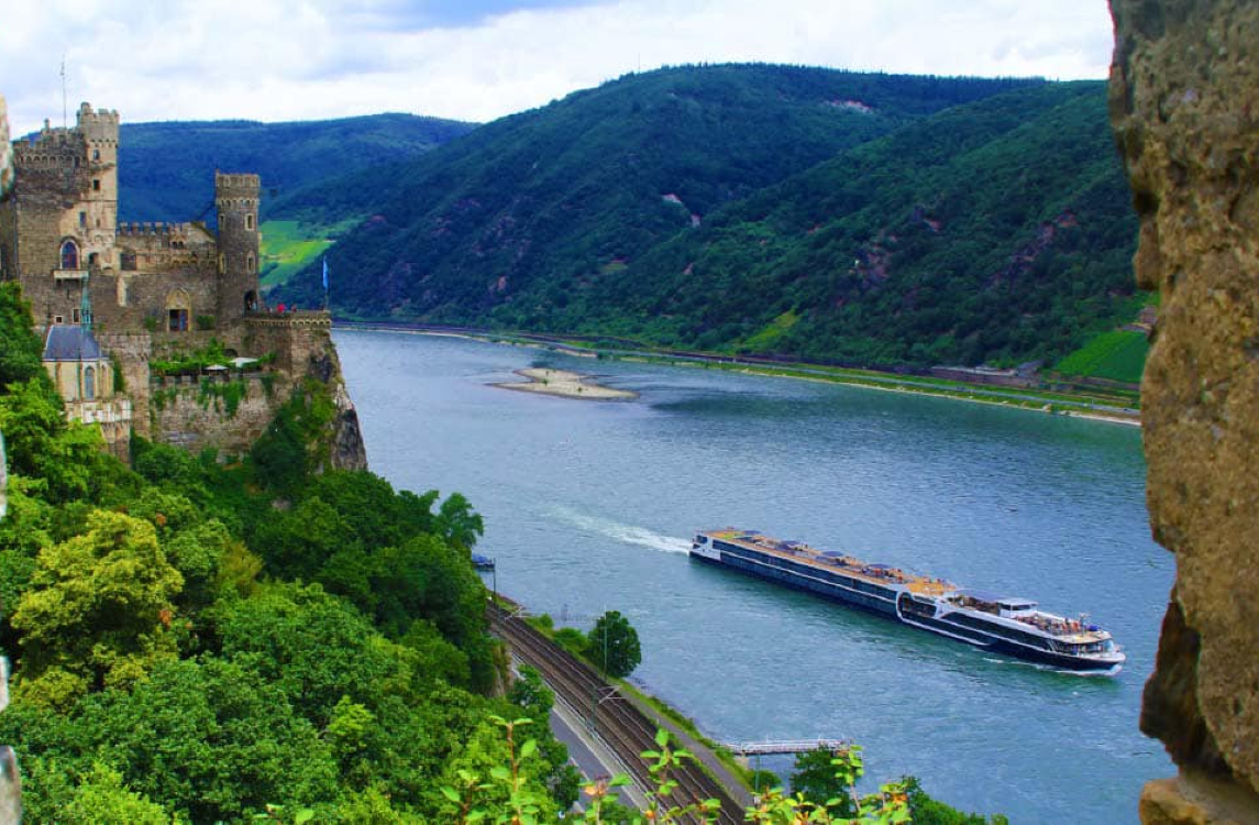 River cruise ship on the Rhine River with castles