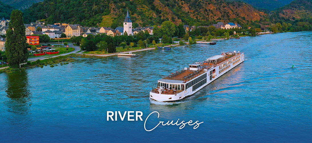 Luxury river cruise ship sailing past a charming European village